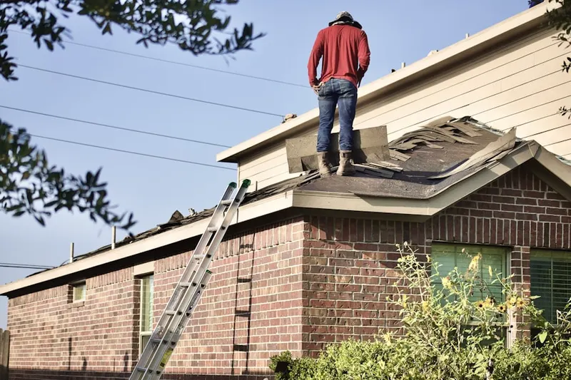 Professional roofer working on a residential roof in Rylie